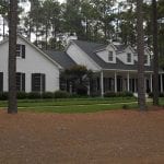 Vinyl House with custom roofing designed by Creed & Garner Roofing Company Inc. in Aberdeen, NC.